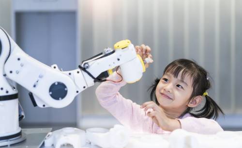 young student exploring a machine