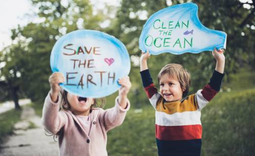 children carrying custom-made posters to save the earth and the oceans